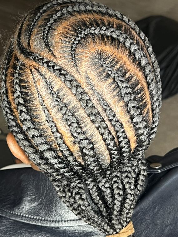 Freestyle cornrows curved into a leaf pattern